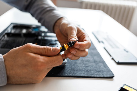 Close up of male hands holding a small screwdriver, preparing for fixing