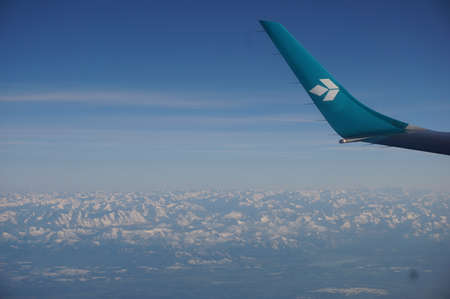 Photo through the window of a passenger plane Air Dolomitiのeditorial素材