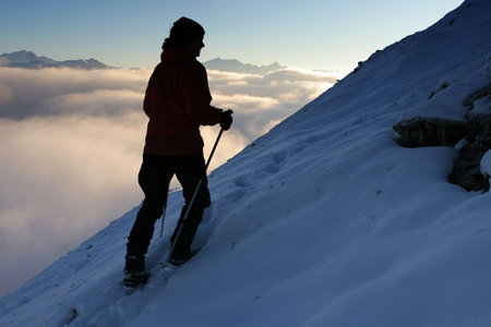 Winter mountain trekking - silhouette of a climber