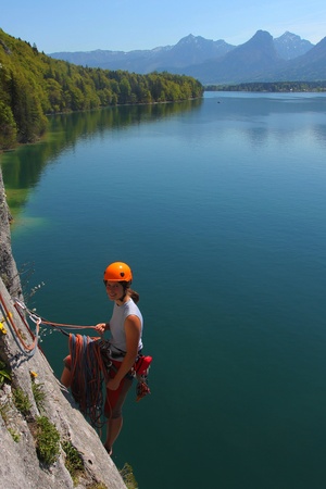 Young woman with climbing gear above alpine lake in Upper Austriaの写真素材