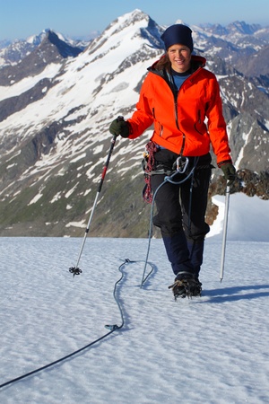 Climber ascending snow slope in the Austrian Alpsの写真素材