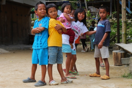 MAMASA, INDONESIA - JULY 24: Group of indonesian children posing in front of their house on July 24, 2011 in Mamasa, Indonesiaのeditorial素材