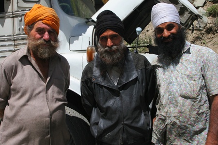 INDIA - SEPTEMBER 2: Three Sikh drivers in front of their lorry, north India September 2, 2008 in Indiaのeditorial素材