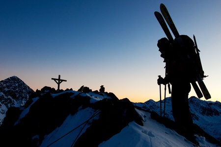 Young woman with ski in winter mountainsの写真素材