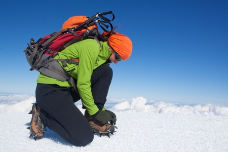 Young woman putting on her cramponsの写真素材