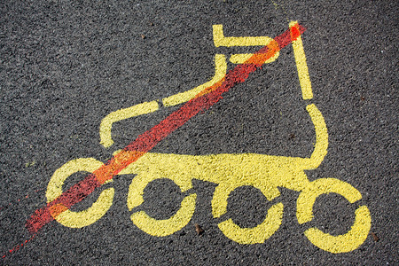 Sign with restriction of inline skating painted on a tarmac roadの写真素材