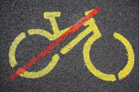Sign with restriction of cycling painted on a tarmac roadの写真素材