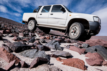Off-road 4WD car driving on rough terrain