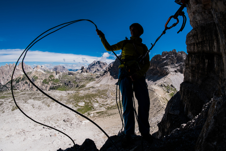 Silhouette of a climber during multi-pitch mountsin ascentの写真素材