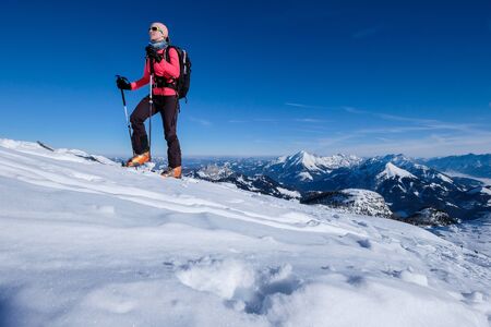 Young woman doing skitouring in the Austrian Alpsの写真素材