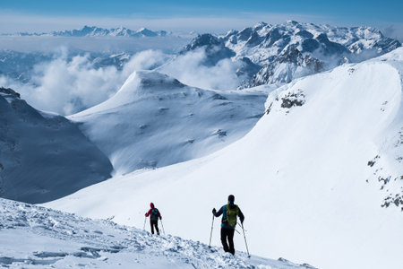 Silhouettes of two persons in the winter mountains