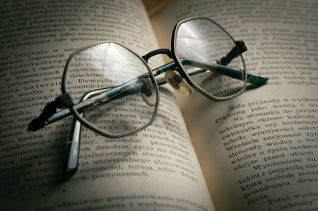 glasses on old bookの写真素材