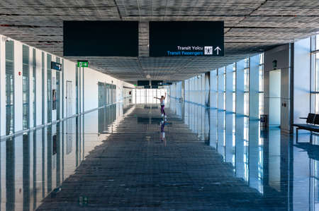 05/26/2019 Bodrum Airport. Turkey. Small girl running along long corridor out of boredom while awaiting for her flight.のeditorial素材