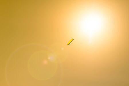 Paraglider ascend towards sun. Modern Icarusの写真素材
