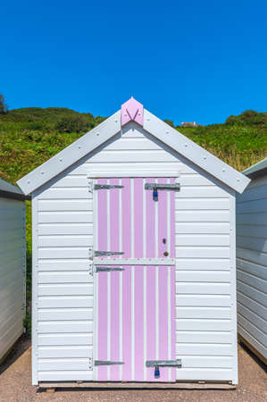 Colourful beach houses. Row of multicolored beach huts against blue sky.の写真素材