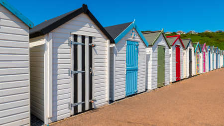Colourful beach houses. Row of multicolored beach huts against blue sky.の写真素材