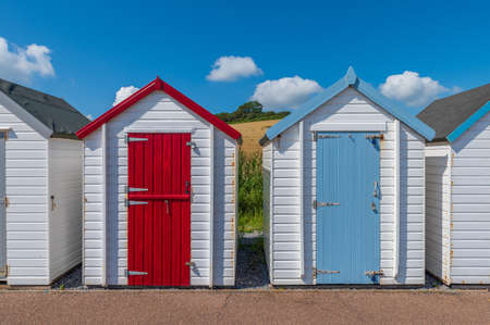 Colourful beach houses. Row of multicolored beach huts against blue sky.の写真素材