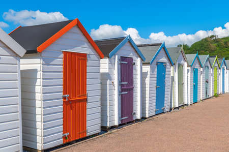 Colourful beach houses. Row of multicolored beach huts against blue sky.の写真素材