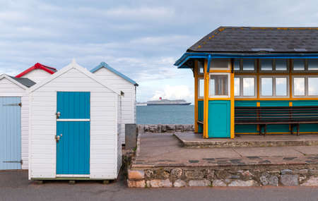 Colourful beach houses. Row of multicolored beach huts against blue sky.の写真素材