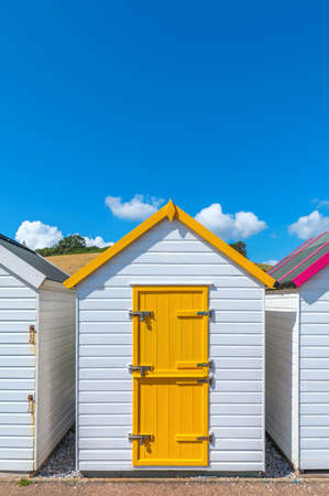 Colourful beach houses. Row of multicolored beach huts against blue sky.の写真素材