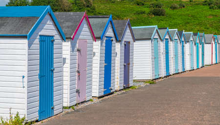 Colourful beach houses. Row of multicolored beach huts against blue sky.の写真素材