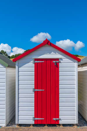 Colourful beach houses. Row of multicolored beach huts against blue sky.の写真素材