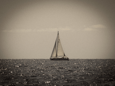 Sailing yacht in Croatia, windy summer on the boat between rocky islands of the Mediterranean seaの写真素材