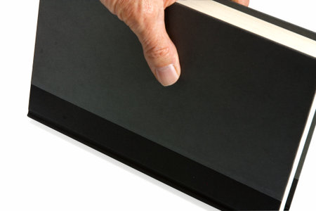 Hard back book being picked up my a man's hand