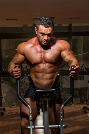 male bodybuilder using the elliptical machineの写真素材
