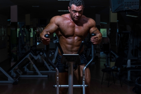 male bodybuilder using the elliptical machineの写真素材