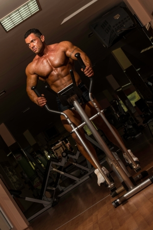 male bodybuilder using the elliptical machineの写真素材