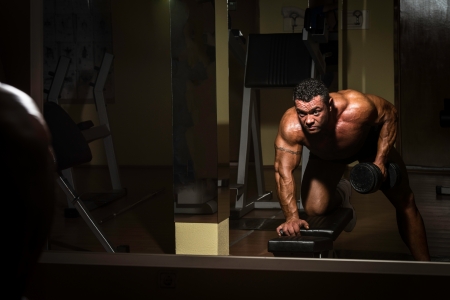 male bodybuilder doing heavy weight exercise for backの写真素材