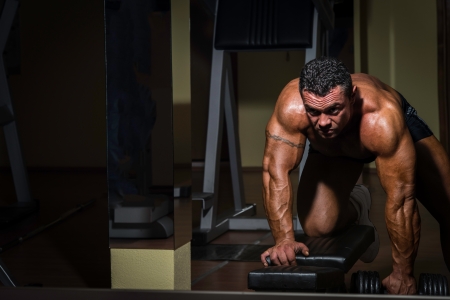 male bodybuilder doing heavy weight exercise for backの写真素材