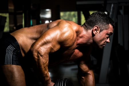 male bodybuilder doing heavy weight exercise for backの写真素材
