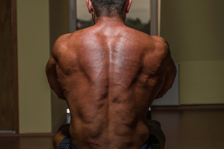 male bodybuilder flexing his backの写真素材
