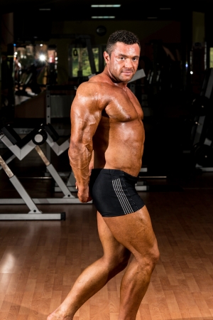 muscular bodybuilder showing his side tricepsの写真素材