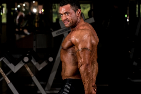 muscular bodybuilder showing his side tricepsの写真素材