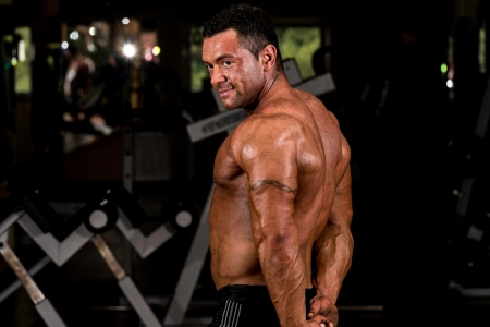 muscular bodybuilder showing his side tricepsの写真素材