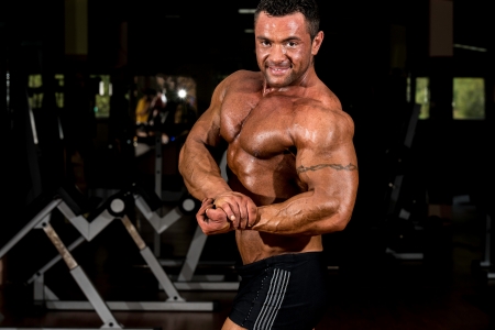 muscular bodybuilder showing his side chestの写真素材