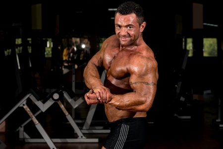 muscular bodybuilder showing his side chestの写真素材