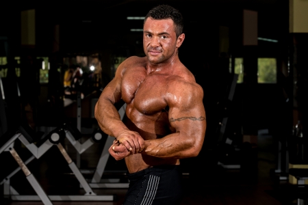 muscular bodybuilder showing his side chestの写真素材