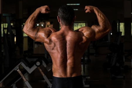 muscular bodybuilder showing his back double bicepsの写真素材