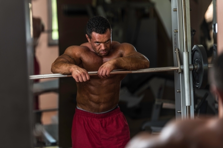 bodybuilder resting after doing heavy weight exerciseの写真素材