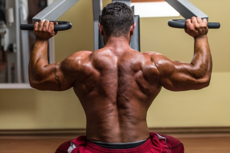 shirtless body builder doing military press for shoulderの写真素材