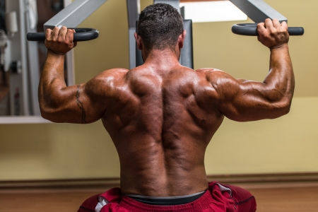 shirtless body builder doing military press for shoulderの写真素材