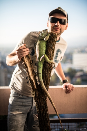 portrait of the young man with the iguanaの写真素材