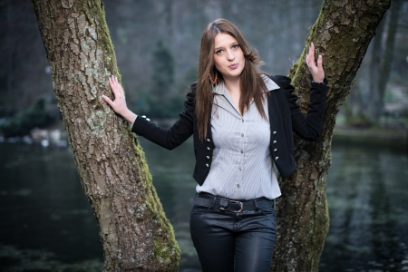 young woman posing with lips thrown out at the lakeの写真素材