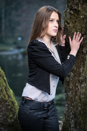 young woman posing at the treeの写真素材