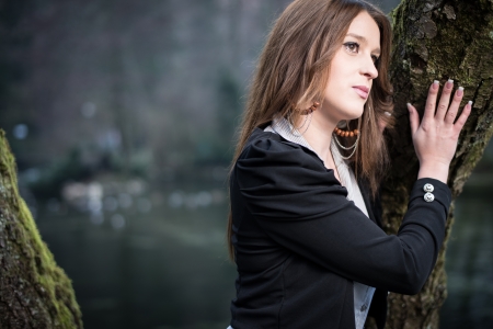 young woman posing at the treeの写真素材