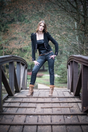 young woman standing at the bridgeの写真素材